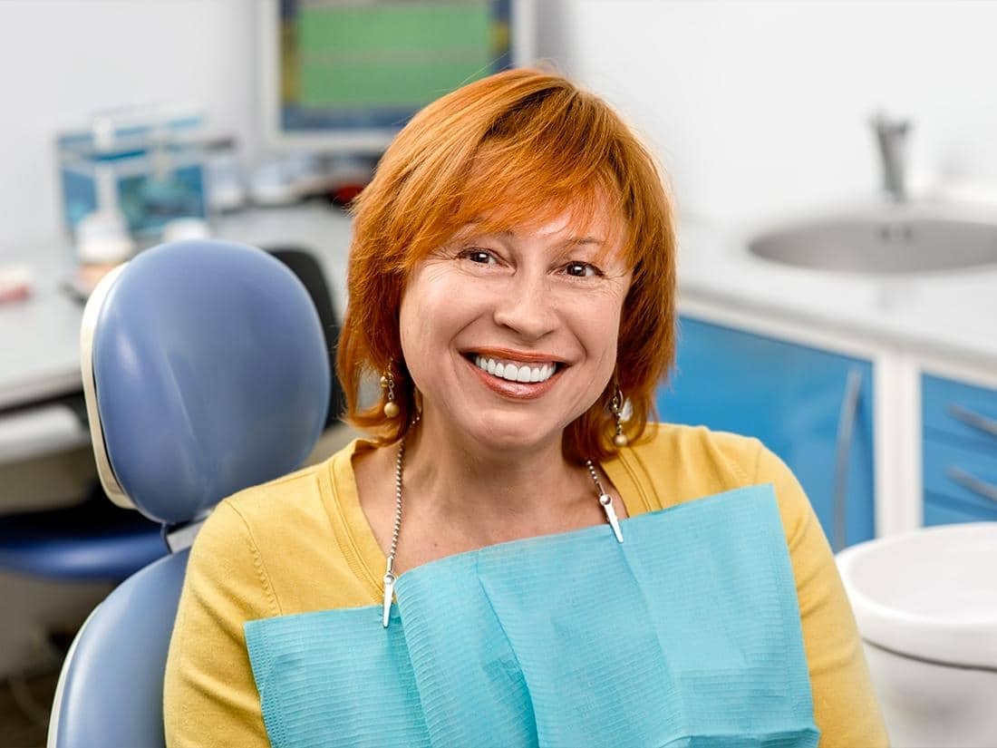 Patient smiling after professional teeth whitening treatment